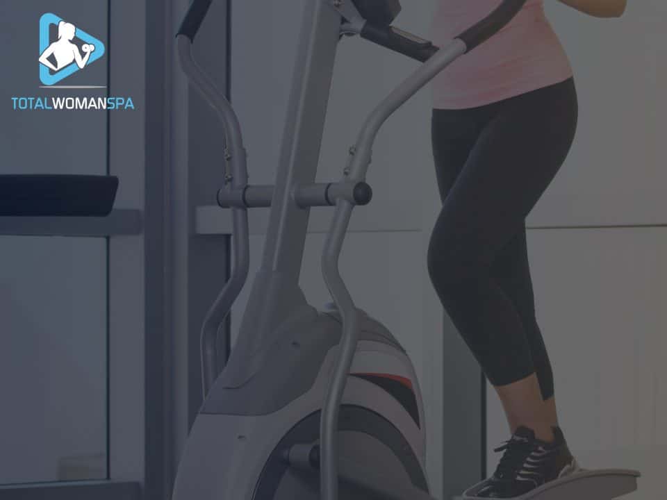Woman Exercising On Cross Trainer