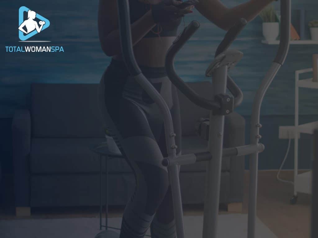 Woman in Sportswear Using the Elliptical at Home