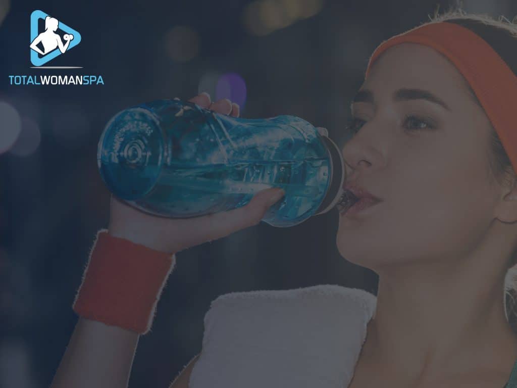Sporty Woman Drinking Water at Gym