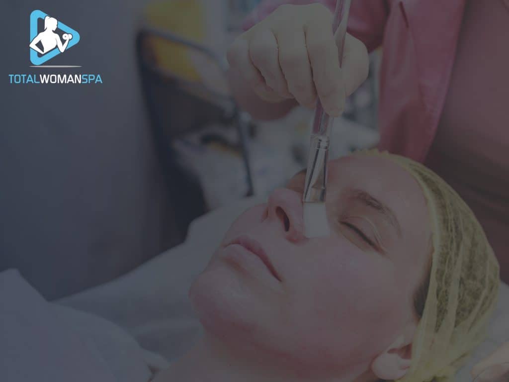 Beautician Applying Chemical Peel with Brush